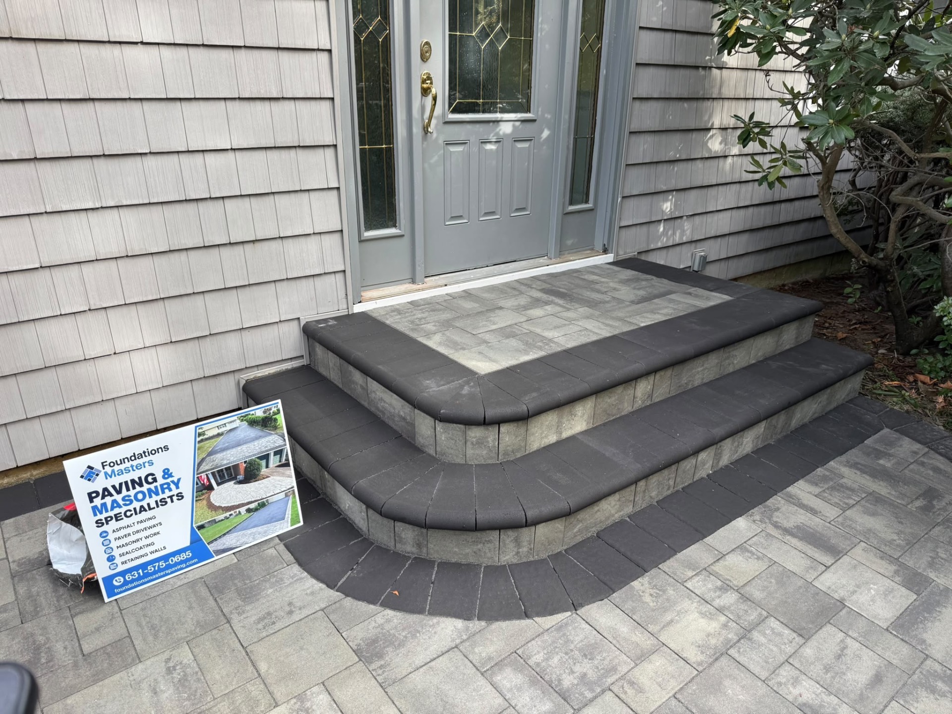 Custom gray interlock front steps with charcoal borders on Long Island